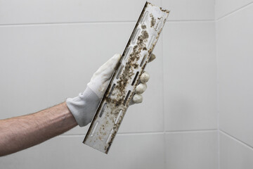 Stained Mold Drain in Plumber Hand
