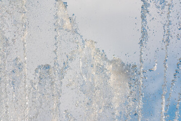 Splashes and jets of water against light background.