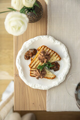 Chicken liver pate on grilled toast with fig jam in restaurant setting