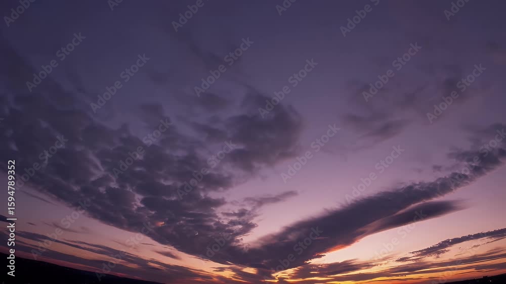 Wall mural mesmerizing 4k timelapse of a sunset sky with vibrant colors blending and shifting as clouds gracefu