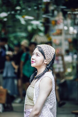 Beautiful Asian woman smiling in outdoor scene, vintage tone.