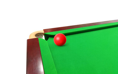 Red snooker ball on the snooker table, left corner of the table.