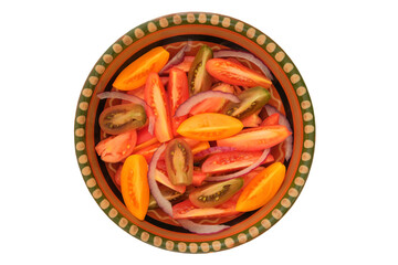 Red sliced tomato in rustic bowl. Tomatoes in a clay plate isolate on white background. Juicy tomato. Top view.