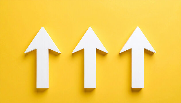 Three white wooden arrow pointing upwards on yellow. Business, market decline or economic.
