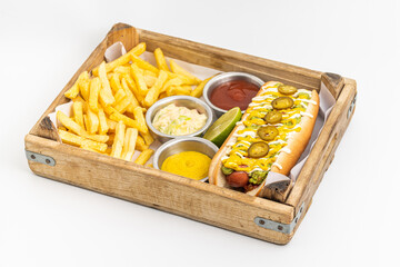 Delicious hot dog sandwich with sauces and fries on the side