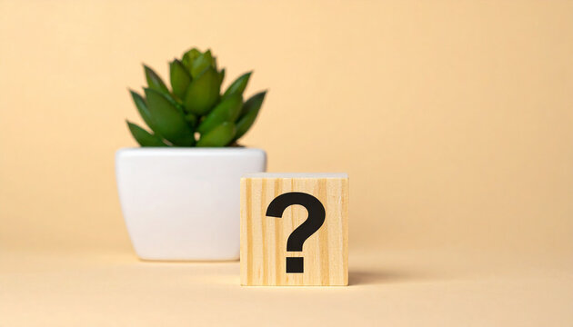 Wooden block with question mark, green plants on backdrop. FAQ and QA. Problem solution.