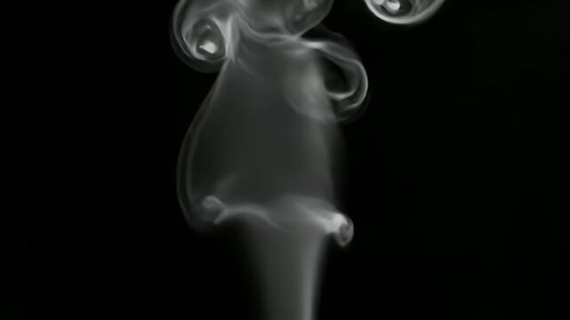 Thin plume of white incense smoke rising on black background.
