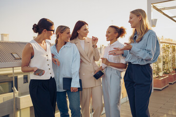 Diverse women network outdoors, showcasing style and making connections in a vibrant setting