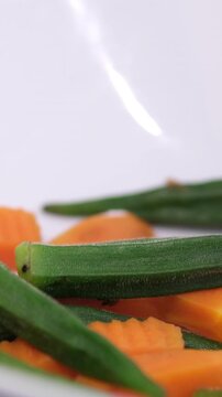 Carrots okra vegetables on stall in vegetables market. Pile of Bright Green Okra Set out at Farmer' Summerville, South Carolina. okra or Abelmoschus esculentus on market stall.