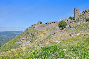 Ancient stone amphitheater clings to a steep mountain slope, overlooking Bergama's valley, Pergamon, Turkey