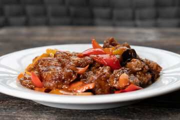 Stir Fried Eel with Vegetables on wooden background. Chinese food. Asian cuisine