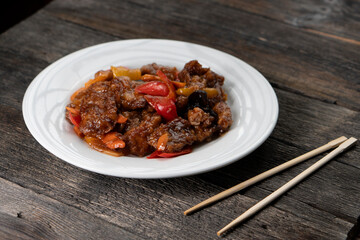 Stir Fried Eel with Vegetables on wooden background. Chinese food. Asian cuisine