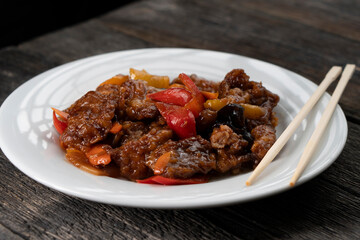 Stir Fried Eel with Vegetables on wooden background. Chinese food. Asian cuisine