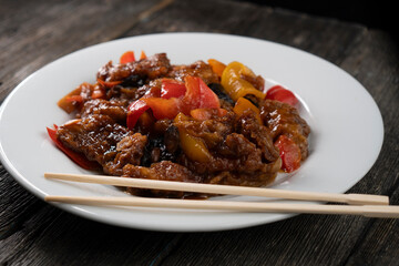 Stir Fried Eel with Vegetables on wooden background. Chinese food. Asian cuisine