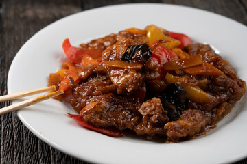 Stir Fried Eel with Vegetables on wooden background. Chinese food. Asian cuisine