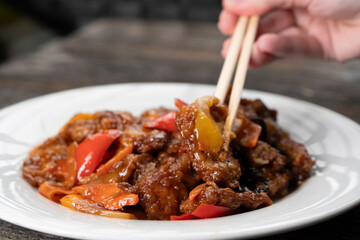 Stir Fried Eel with Vegetables on wooden background. Chinese food. Asian cuisine