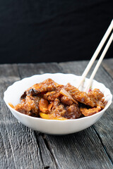 Stir Fried Eel with Vegetables on wooden background. Chinese food. Asian cuisine