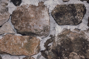 Unusual stone masonry with rocks of different sizes. Natural textured background