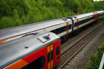 Codnor, Derbyshire, England – July 16 2025: High speed passenger train traveling through lush green countryside