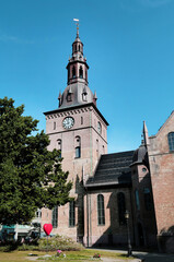 Beautiful old clock tower on a clear sunny day against a clear blue sky, Norway. Travel landscape sights of Europe.