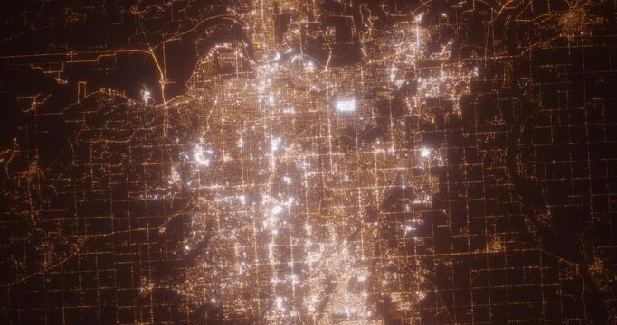 Omaha (Nebraska, USA) aerial view at night. Top view on modern city with street lights. Camera is zooming out, rotating counterclockwise. Vertical video. The north is on the left side