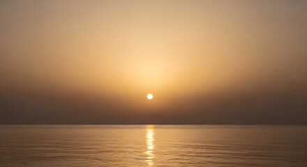 Fototapeta premium Golden Sunset Over Calm Ocean Water with Warm Hues
