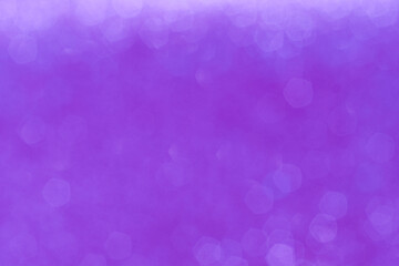 Cold purple bokeh background with soft glowing highlights