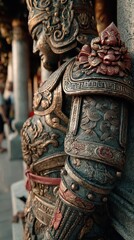 Fototapeta premium Intricate warrior statue with detailed armor and adornments in a cultural temple setting