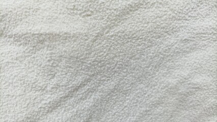 white fabric texture, Terry cloth, yellow towel texture background. Wrinkled and crumped soft fluffy textile bath or beach towel material. Top view, close up.
