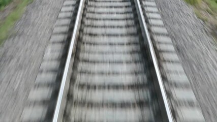 Fleeing away the ties and rails. The view from the back window of the train car.