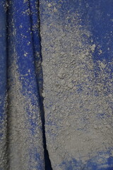 Blue construction worker suite with concrete stains