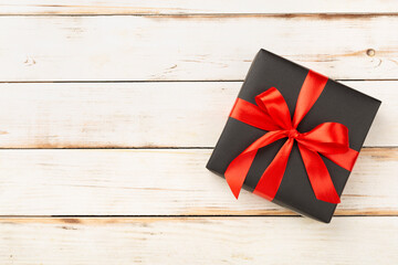 Black gift boxes on wooden background, top view. Black Friday concept