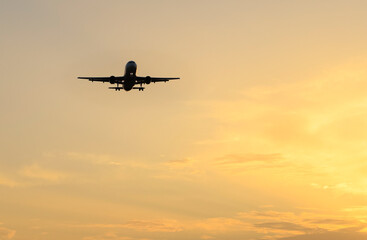 Plane flying with clearly sky at sunset