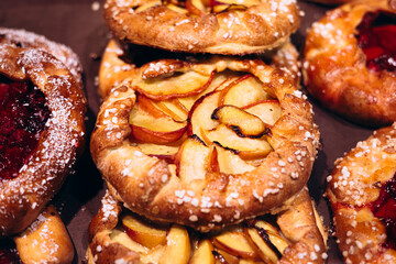 Close-up of multiple peach galettes arranged in bakery display.