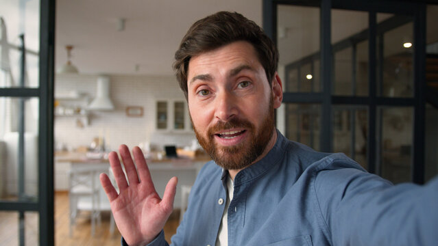 Glad Caucasian man male father smiling recording video blog speaking camera mobile phone tech at home demonstrating new house happy guy dad discuss vlog household waving hand communication streaming