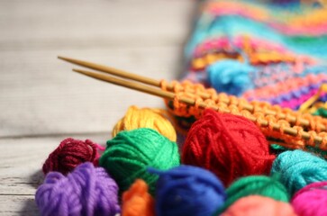Knitting process and multicolor canvas and clews balls yarn different colors photo 