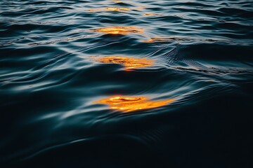 Golden sunlight reflecting on the surface of a dark blue ocean creating a mesmerizing pattern