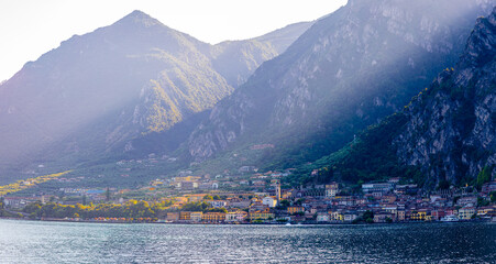 Fototapeta premium Scenic waterfront of Limone sul Garda, with village buildings and mountains in the background.