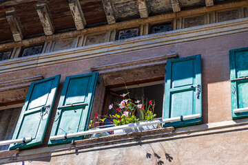 Scenic waterfront of Limone sul Garda, with village buildings and mountains in the background.