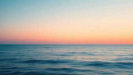 Obraz premium Ocean and Sunset with a soft gradient from deep blue to warm peach