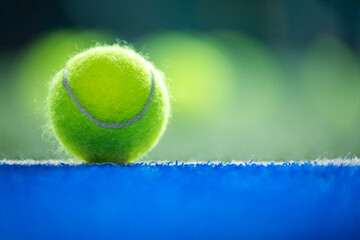 Padel or tennis ball. Background with copy space. Ball at sports court. Social media template....