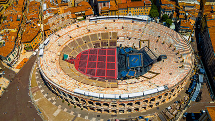 Aerial view of the historic Verona Arena, an ancient Roman amphitheater surrounded by orange-tiled buildings in Verona, Italy