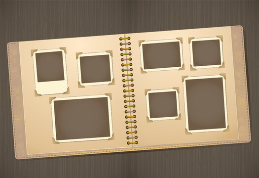 Vintage photo album mockup with empty black photo placeholders on an open spiral-bound scrapbook. The album lies on a wooden surface, showcasing a nostalgic design with beige pages, corner photo mount