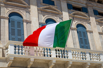 Close-up of a waving Italian flag with vibrant green, white, and red stripes fluttering in the wind