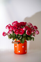 Bouquete of fresh pink roses in vintage milk can