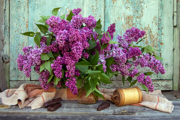 Lilac bouquet and chocolate on a vintage background