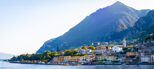 Scenic waterfront of Limone sul Garda, with village buildings and mountains in the background.