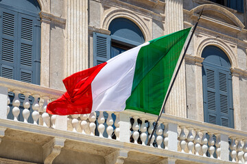 Close-up of a waving Italian flag with vibrant green, white, and red stripes fluttering in the wind
