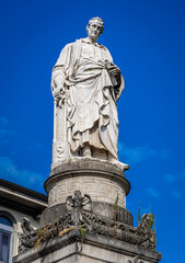 Neoclassical Volta Temple monument in Como, Italy, with columns, domed roof, and lakeside park setting under clear summer skies.