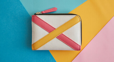 Modern geometric wallet with pink and yellow stripes on a colorful background